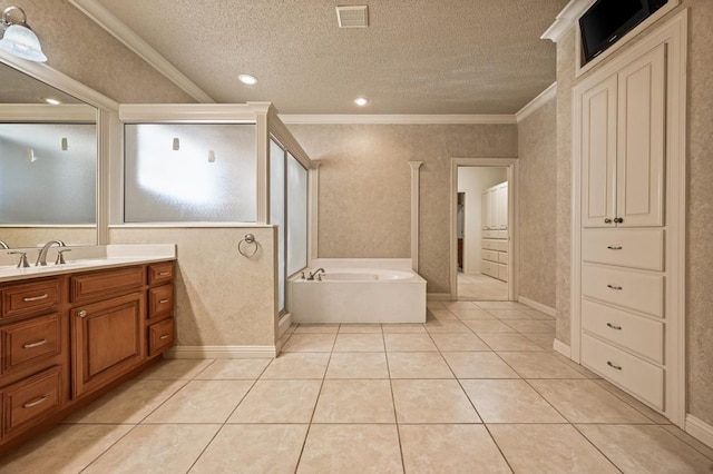 bathroom with crown molding, vanity, a textured ceiling, tile patterned floors, and a bathing tub