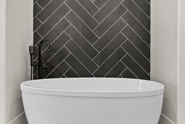 full bathroom with baseboards and a freestanding tub