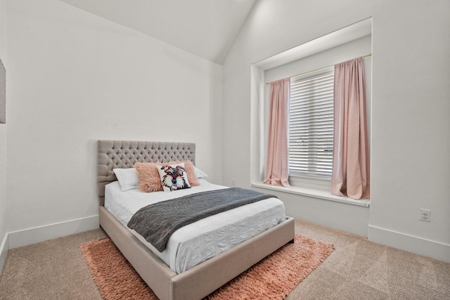 bedroom featuring vaulted ceiling, baseboards, and carpet