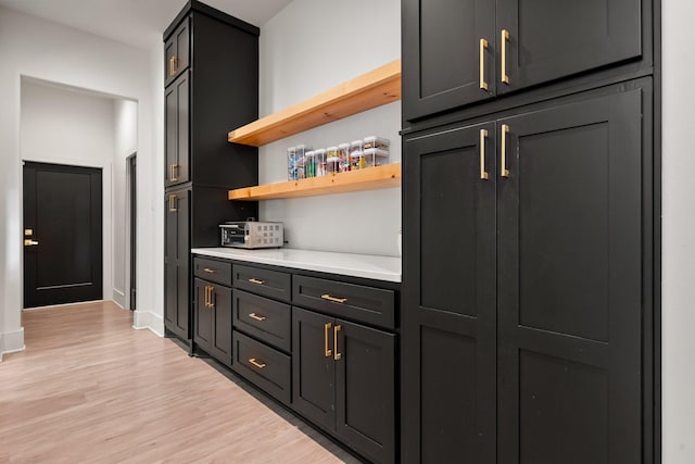 bar with baseboards and light wood finished floors