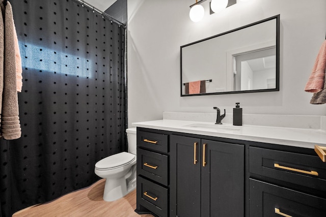 full bathroom with a shower with curtain, wood finished floors, vanity, and toilet