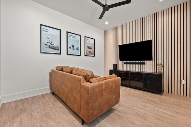 living room with a ceiling fan, baseboards, recessed lighting, and light wood-style flooring
