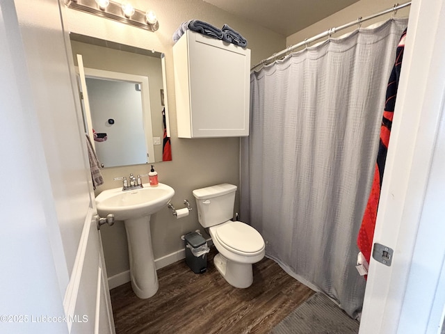 1901 134th St, Lubbock, TX 79423 - full bathroom with wood finished floors, toilet, a sink, baseboards, and a shower with curtain