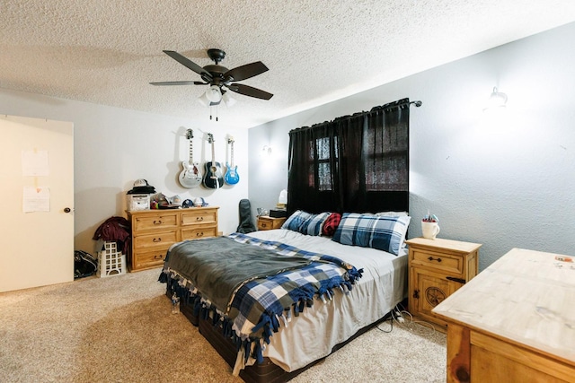 bedroom featuring ceiling fan, light carpet, and a textured ceiling