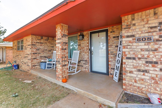 view of exterior entry with a porch