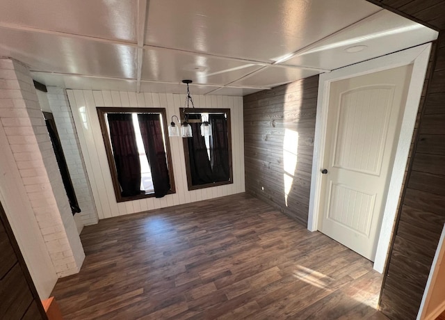 interior space featuring dark hardwood / wood-style floors and wood walls