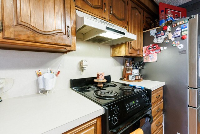 kitchen featuring black / electric stove and stainless steel refrigerator