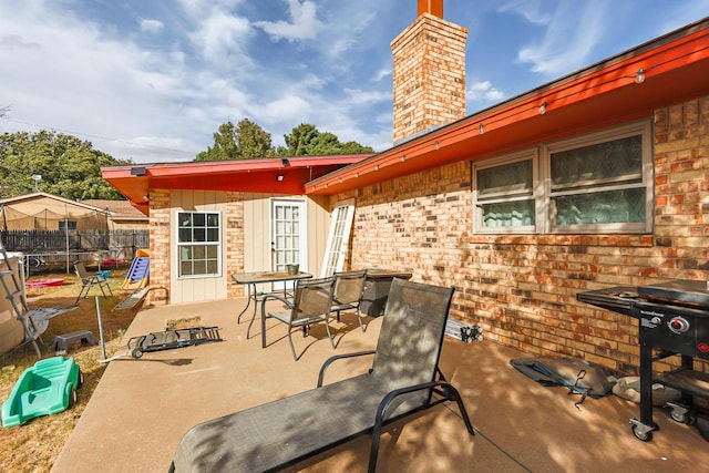 view of patio / terrace featuring a trampoline and a grill