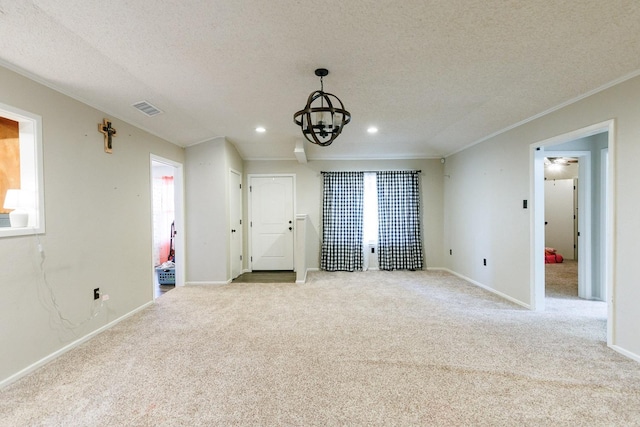 interior space with ornamental molding, a wealth of natural light, a textured ceiling, and a notable chandelier