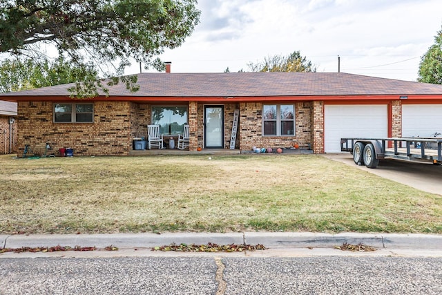 ranch-style home featuring a garage and a front yard