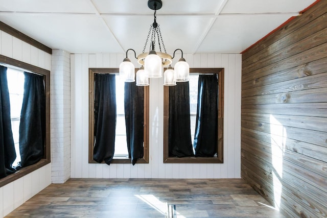 empty room with wood-type flooring and wood walls