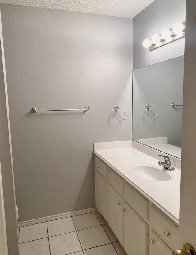 bathroom with vanity, tile patterned floors, and a textured ceiling