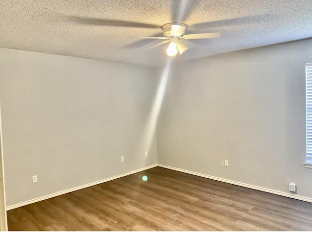 empty room with hardwood / wood-style flooring, ceiling fan, and a textured ceiling