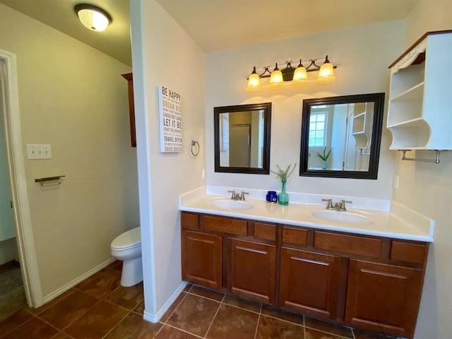 bathroom with vanity, tile patterned floors, and toilet