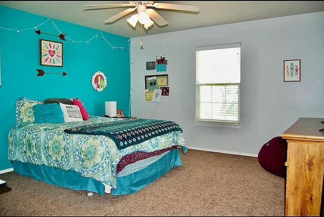 bedroom featuring ceiling fan and carpet