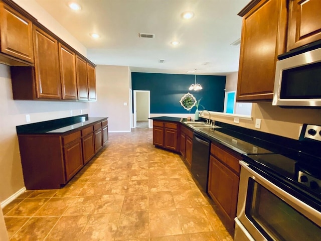 kitchen with stainless steel appliances, sink, pendant lighting, and a chandelier