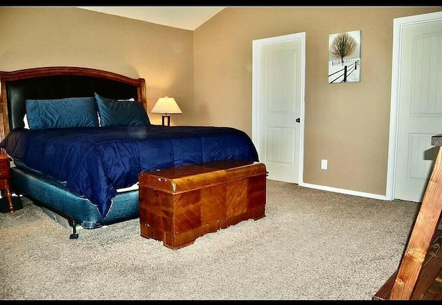 carpeted bedroom featuring vaulted ceiling