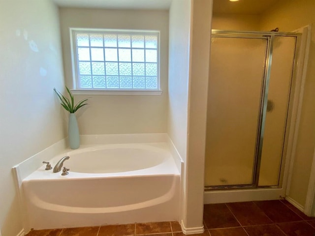 bathroom with tile patterned flooring and separate shower and tub