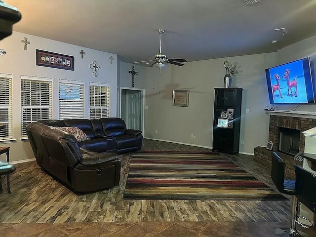 living room featuring ceiling fan and a fireplace