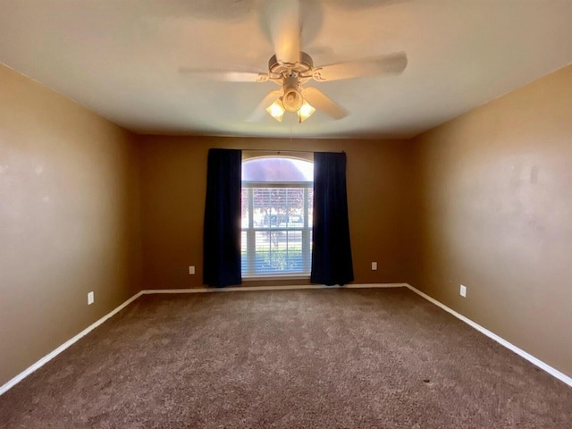 spare room with carpet floors and ceiling fan