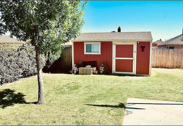 view of outdoor structure featuring a lawn