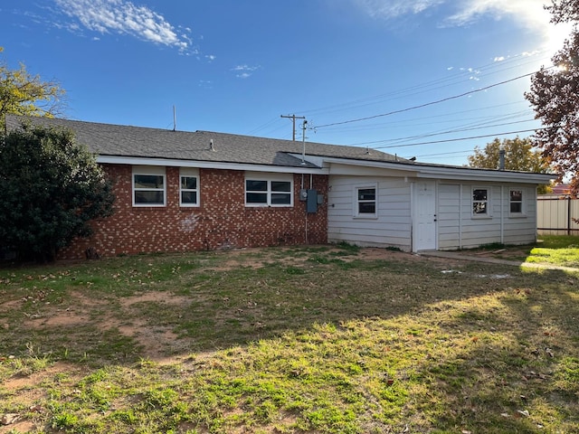 rear view of property featuring a yard