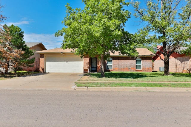 view of front of property featuring a garage and a front lawn