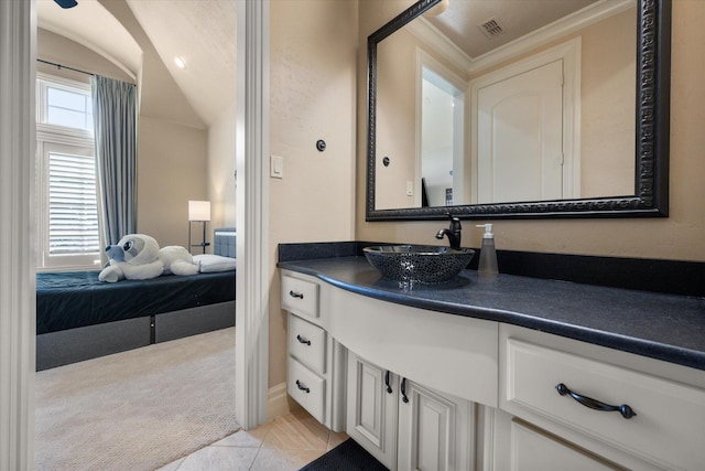 ensuite bathroom featuring a wealth of natural light, visible vents, ensuite bath, and vanity