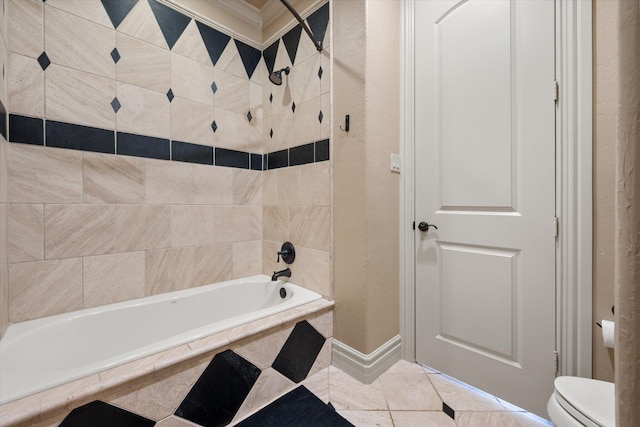 full bathroom featuring tile patterned floors, toilet, and tiled shower / bath