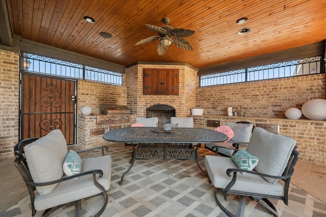 view of patio / terrace featuring area for grilling, outdoor dining area, ceiling fan, and a sink