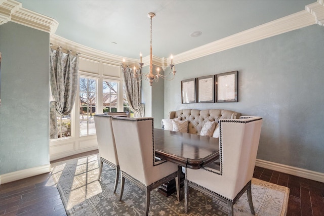 dining area featuring baseboards, wood-type flooring, ornamental molding, and a chandelier