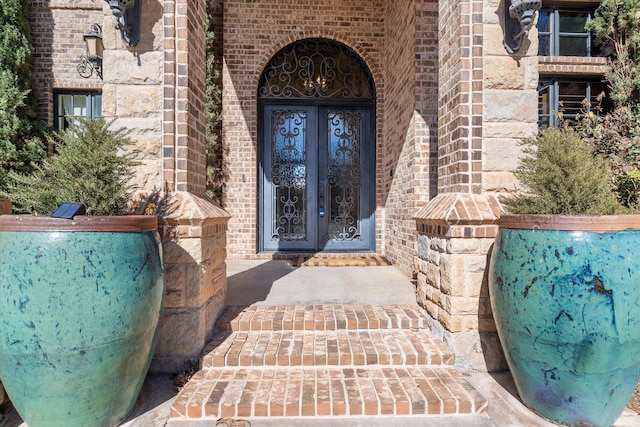 doorway to property with brick siding