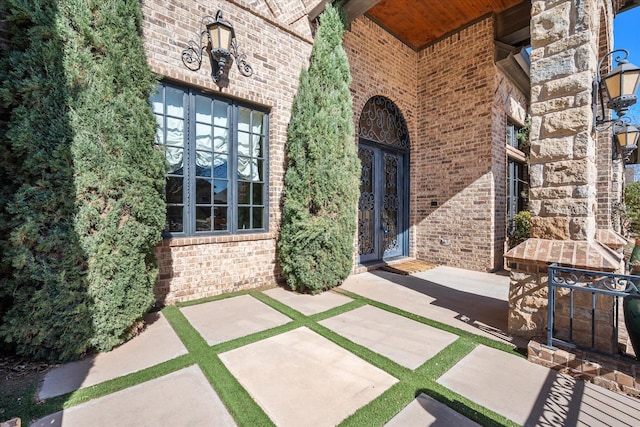 property entrance featuring brick siding