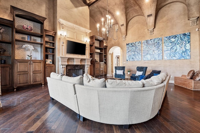 living room featuring built in shelves, high vaulted ceiling, a fireplace, arched walkways, and dark wood-type flooring