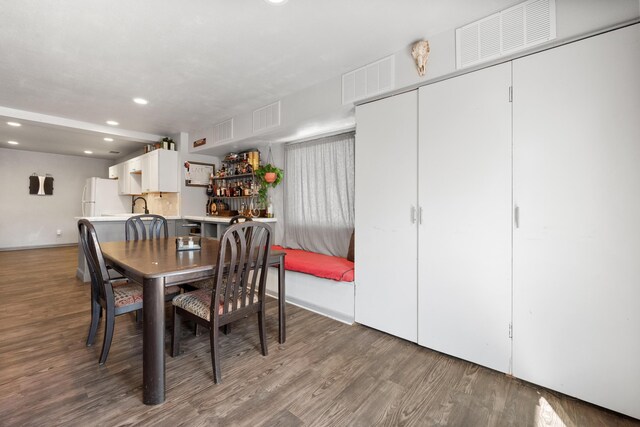 dining area with recessed lighting, visible vents, and wood finished floors
