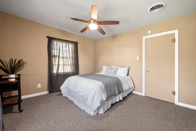 carpeted bedroom with visible vents, a ceiling fan, and baseboards