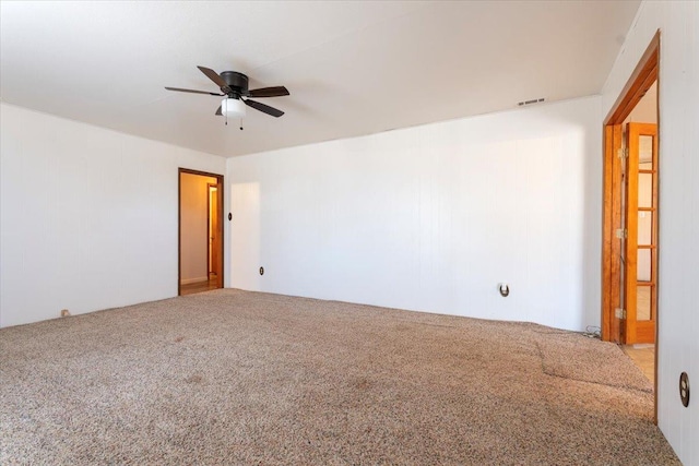 carpeted spare room featuring ceiling fan