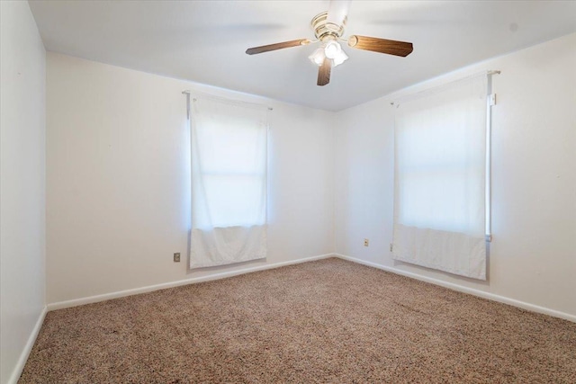 empty room featuring carpet flooring and ceiling fan