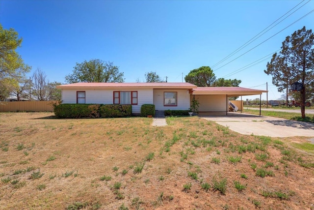 single story home with a front lawn and a carport