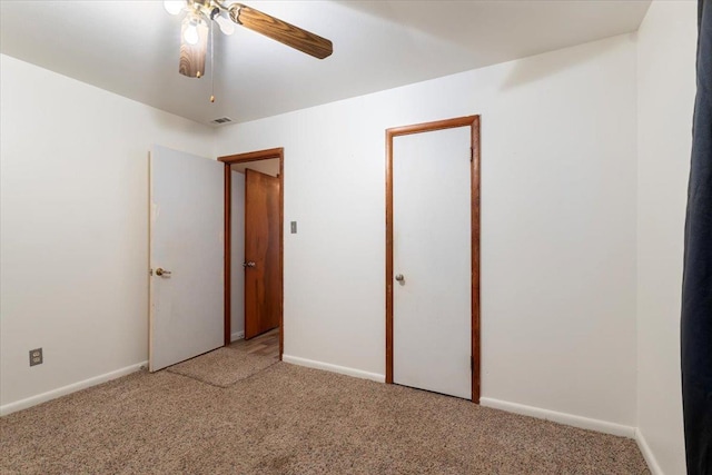 unfurnished bedroom with ceiling fan and carpet