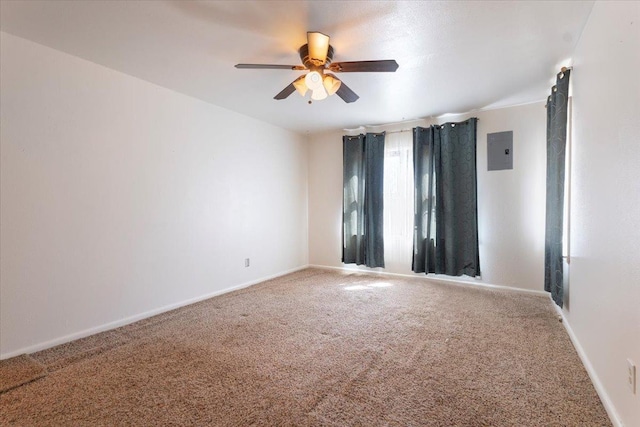 empty room featuring ceiling fan, electric panel, and carpet floors