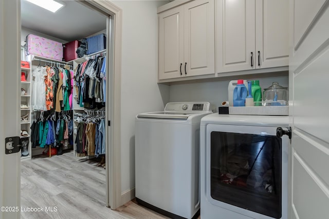 5713 116th St, Lubbock, TX 79424 - washroom with washing machine and clothes dryer, cabinet space, and light wood-style floors