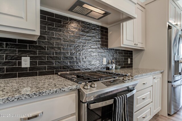 5713 116th St, Lubbock, TX 79424 - kitchen featuring appliances with stainless steel finishes, backsplash, white cabinetry, light stone countertops, and custom range hood