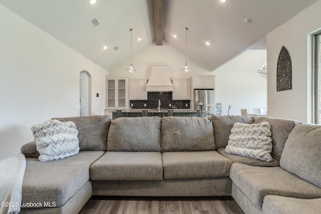 5713 116th St, Lubbock, TX 79424 - living room featuring beamed ceiling, arched walkways, dark wood-type flooring, high vaulted ceiling, and recessed lighting