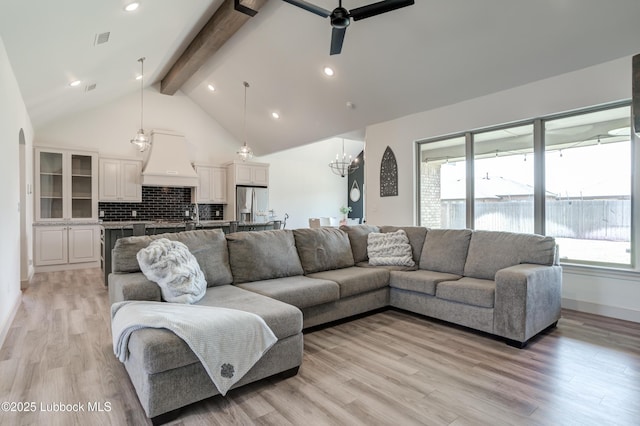 5713 116th St, Lubbock, TX 79424 - living room featuring beamed ceiling, a ceiling fan, light wood-type flooring, a chandelier, and high vaulted ceiling