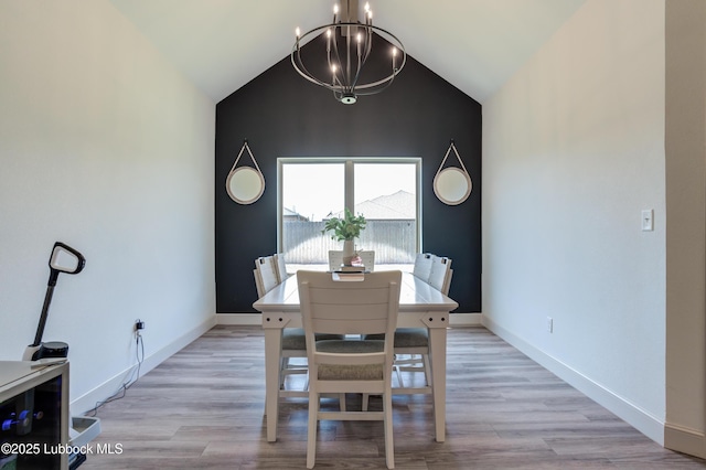 5713 116th St, Lubbock, TX 79424 - dining room with vaulted ceiling, a chandelier, baseboards, and light wood finished floors