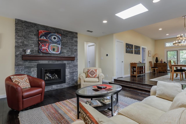 4615 11th St, Lubbock, TX 79416 - living area featuring hardwood / wood-style flooring, a fireplace, a chandelier, and recessed lighting