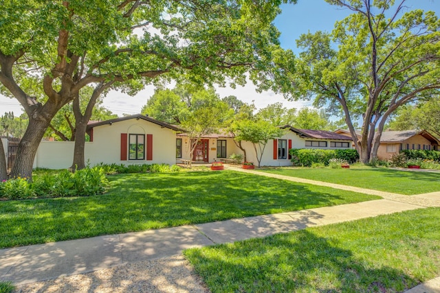 4615 11th St, Lubbock, TX 79416 - ranch-style house featuring stucco siding and a front yard