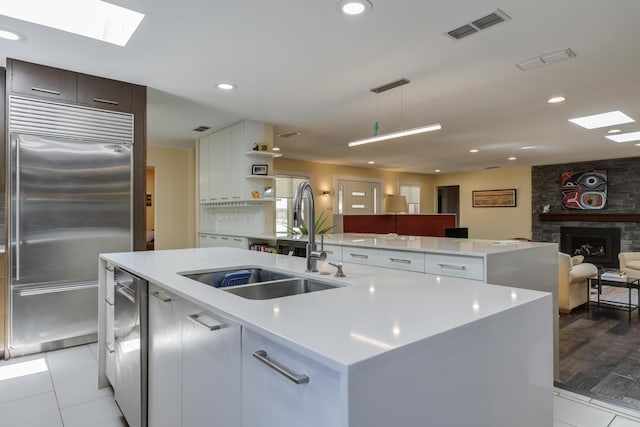4615 11th St, Lubbock, TX 79416 - kitchen featuring stainless steel appliances, a center island with sink, open floor plan, light countertops, and recessed lighting
