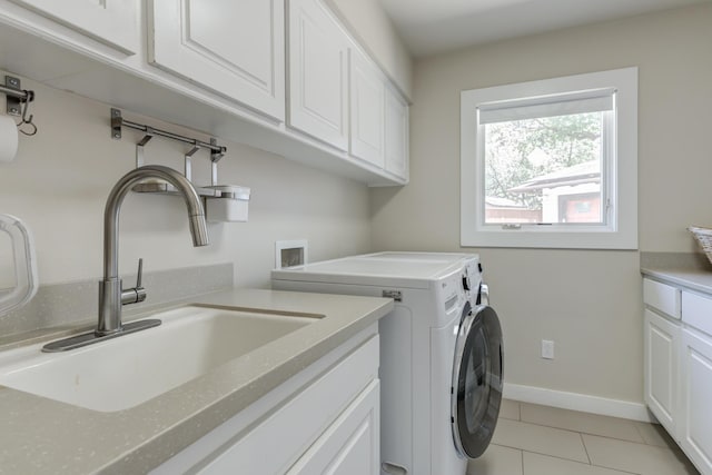 4615 11th St, Lubbock, TX 79416 - washroom featuring cabinet space, independent washer and dryer, and light tile patterned floors
